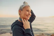 A woman stretching beside the ocean